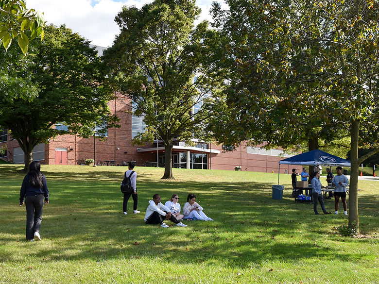 Students enjoying a beautiful, sunny day on the lawn of the Pullo Center.